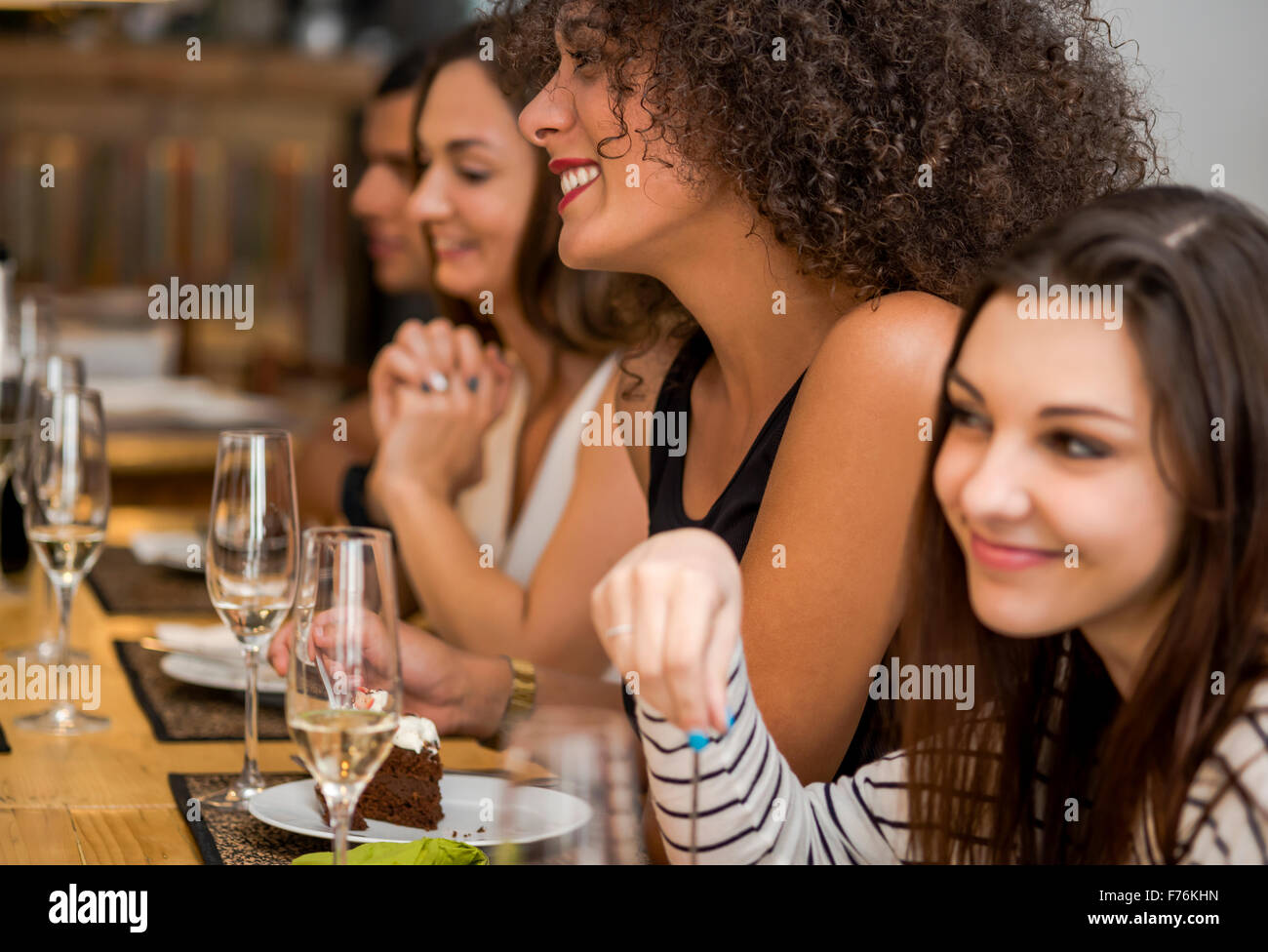 Multi-Ethnic Group of happy friends having fun at the restaurant Stock Photo