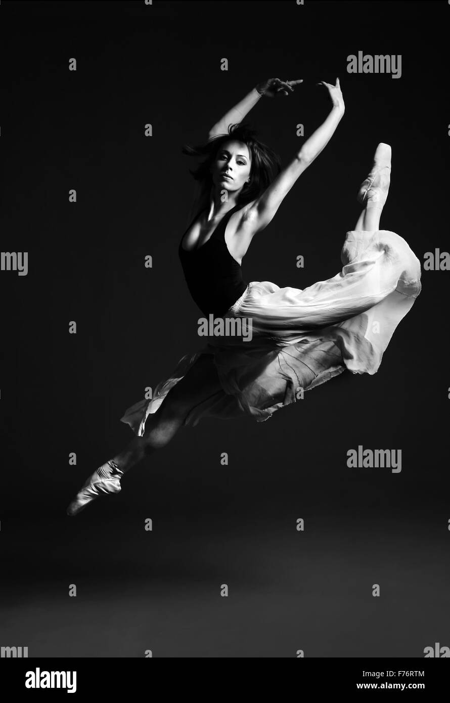 Ballet dancer in striking flying pose, black and white image Stock Photo