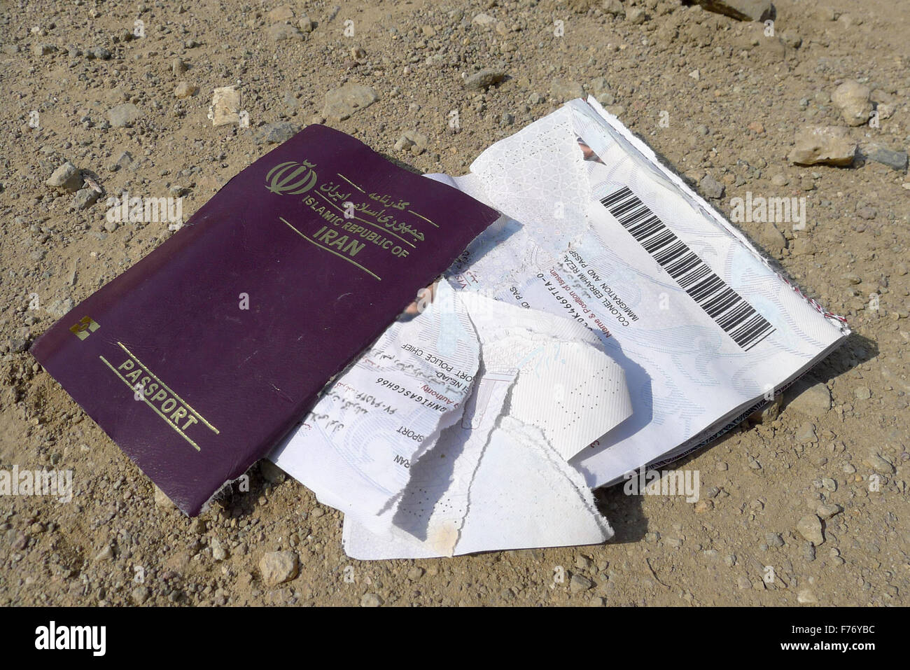 Iran Passport. Torn apart and left at the beach by a refugee after he landed with a dinghy Stock Photo