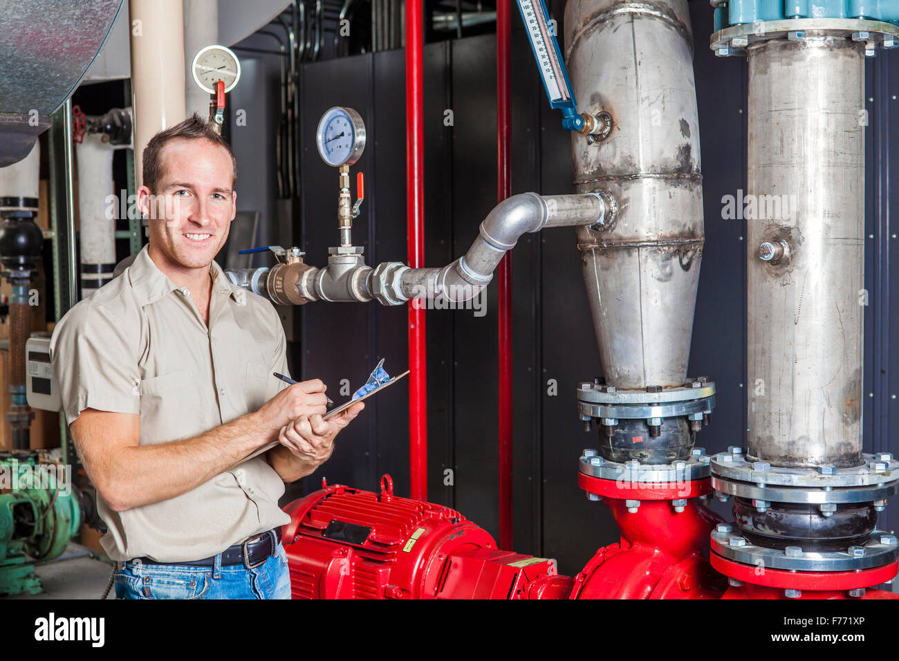 Technician inspecting heating system in boiler room Stock Photo Alamy