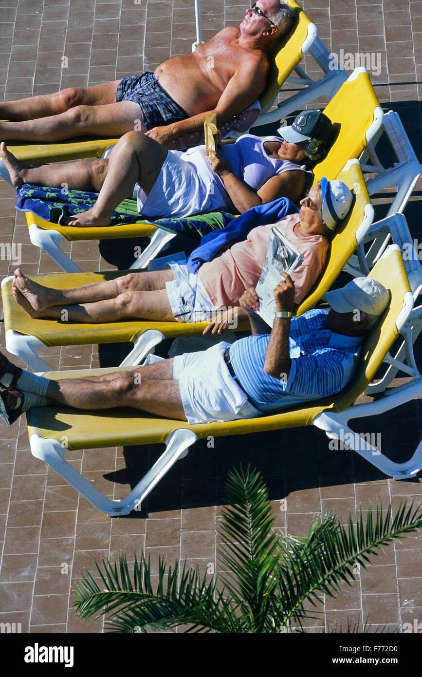 Elderly holiday makers sunbathing in the Algarve. Portugal. Europe Stock Photo