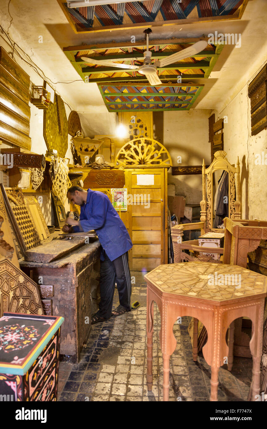 carver working in his workshop at Marrakesh souk Stock Photo