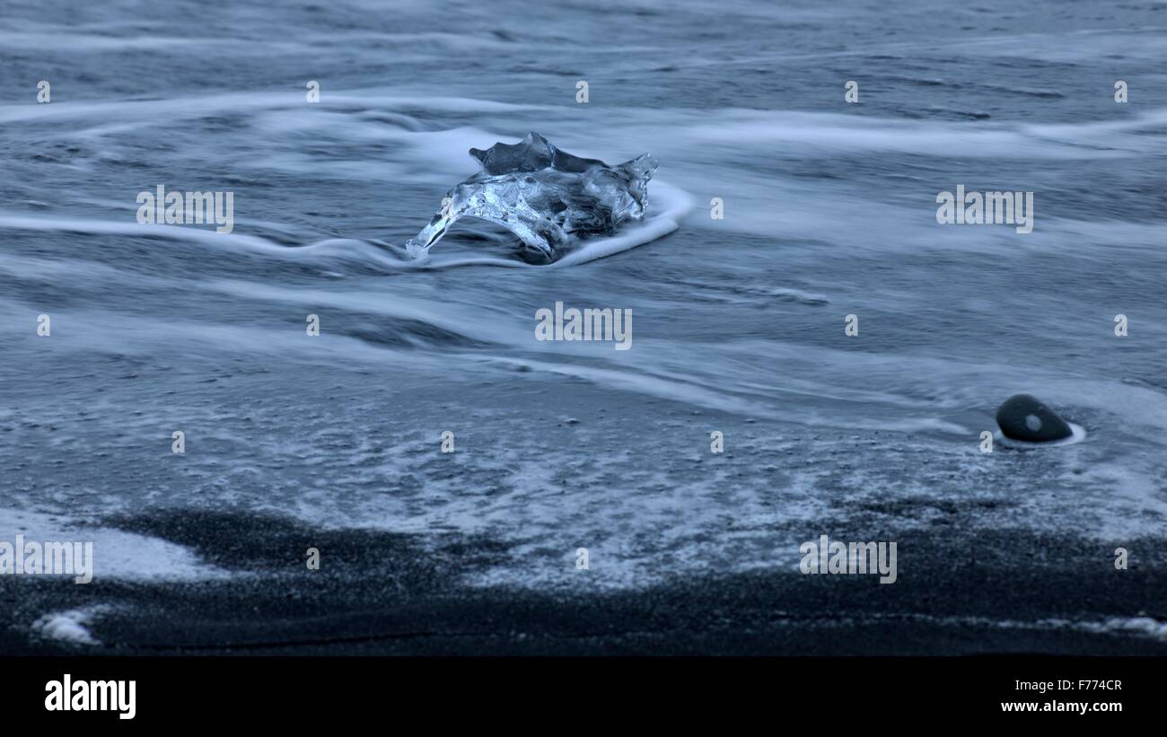 Stranded iceberg beside the lava of Breidarsandur, South Iceland, Iceland Stock Photo