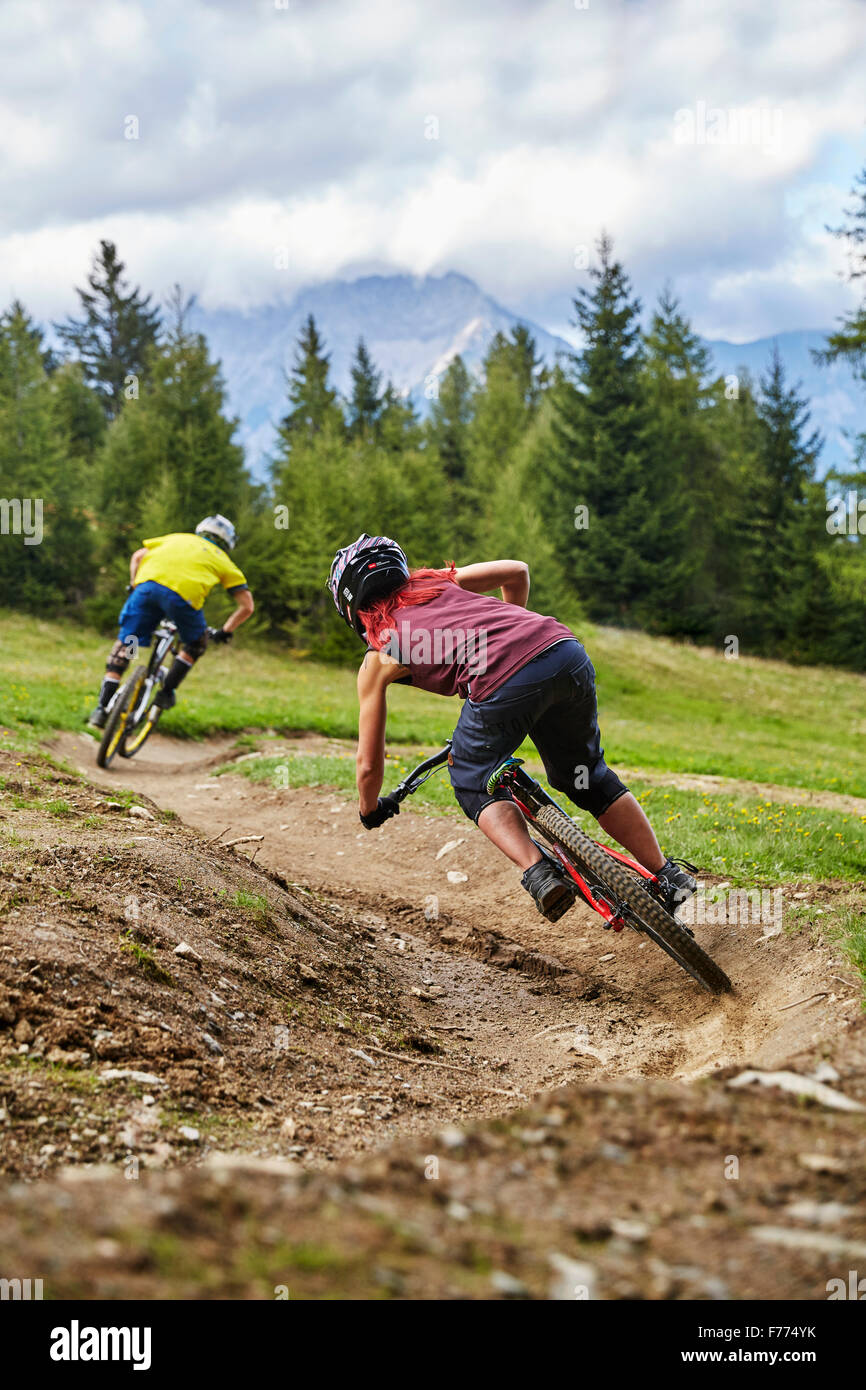 Mountain bikers, downhill bikers riding a downhill trail, Mutterer Alm, Muttereralmpark, Mutters, Tyrol, Austria Stock Photo