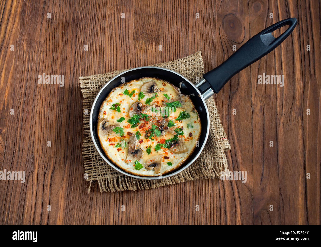 Omelet with mushrooms in a frying-pan Stock Photo
