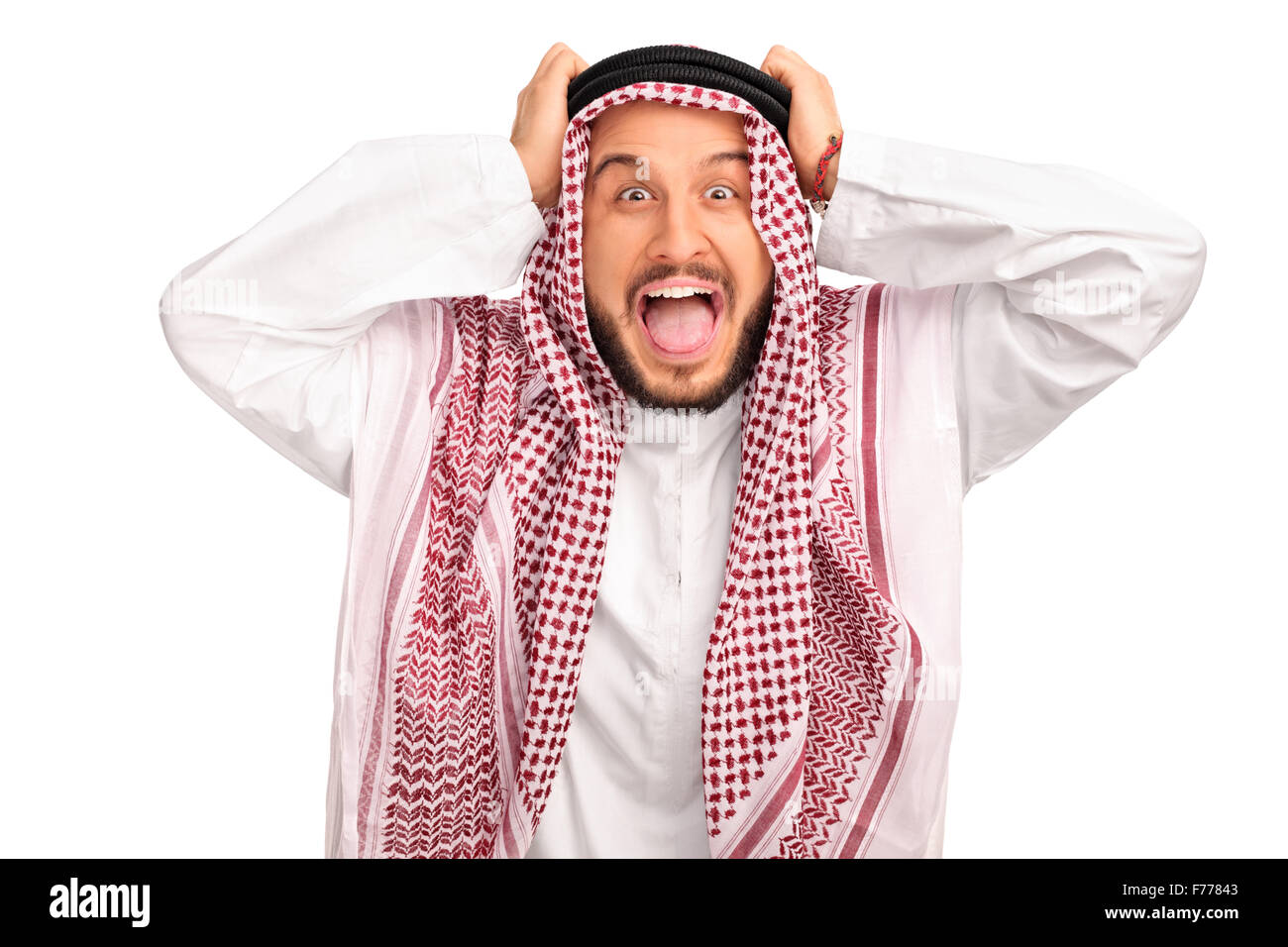 Studio shot of an outraged young Arab posing with his hands on his head isolated on white background Stock Photo