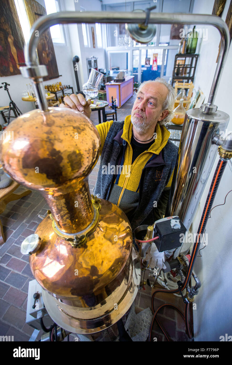 Kluetz, Germany. 24th Nov, 2015. Johann Volk checks the clarity of a seabuckthorn spirit at the still in the new Kluetzer Edelbrand Destille distillery in Kluetz, Germany, 24 November 2015. A bottling plant and art gallery have been operating at the former dairy for years. Since the last few days, 8 brandies and 6 liqueurs are also being produced here. In early 2016, the small business plans to expand with a second, larger distillery. PHOTO: JENS BUETTNER/LMV/dpa/Alamy Live News Stock Photo