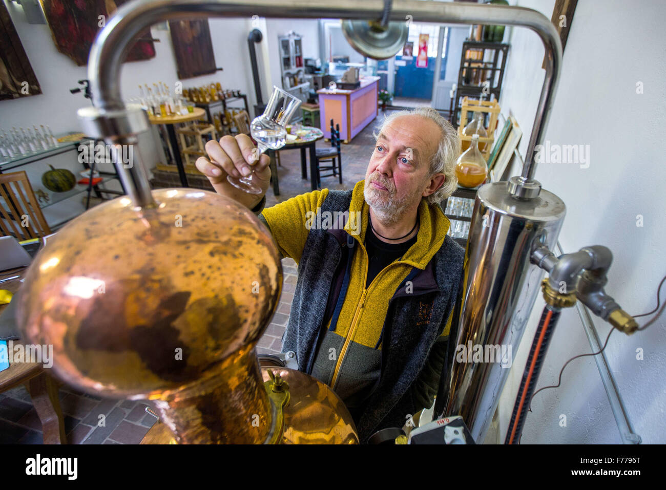 Kluetz, Germany. 24th Nov, 2015. Johann Volk checks the clarity of a seabuckthorn spirit at the still in the new Kluetzer Edelbrand Destille distillery in Kluetz, Germany, 24 November 2015. A bottling plant and art gallery have been operating at the former dairy for years. Since the last few days, 8 brandies and 6 liqueurs are also being produced here. In early 2016, the small business plans to expand with a second, larger distillery. PHOTO: JENS BUETTNER/LMV/dpa/Alamy Live News Stock Photo