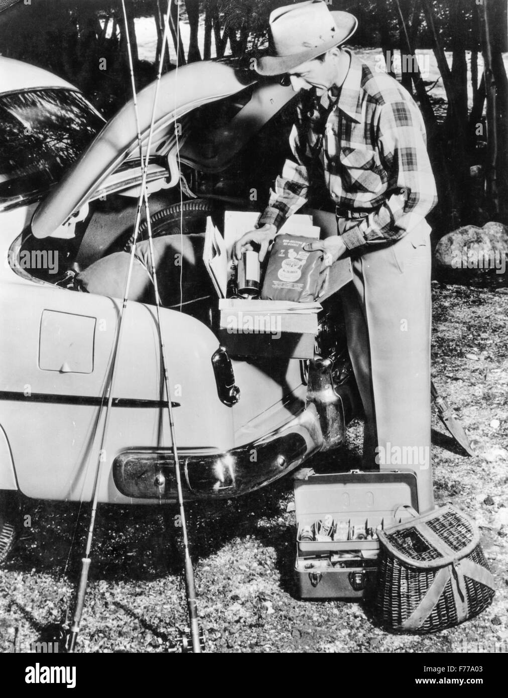 a fisherman organizes the luggage van of his car,1962 Stock Photo