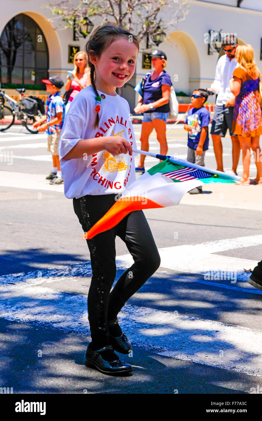 Irish-American 6 year old girl waves her flag at the July 4th parade in Santa Barbara, California Stock Photo