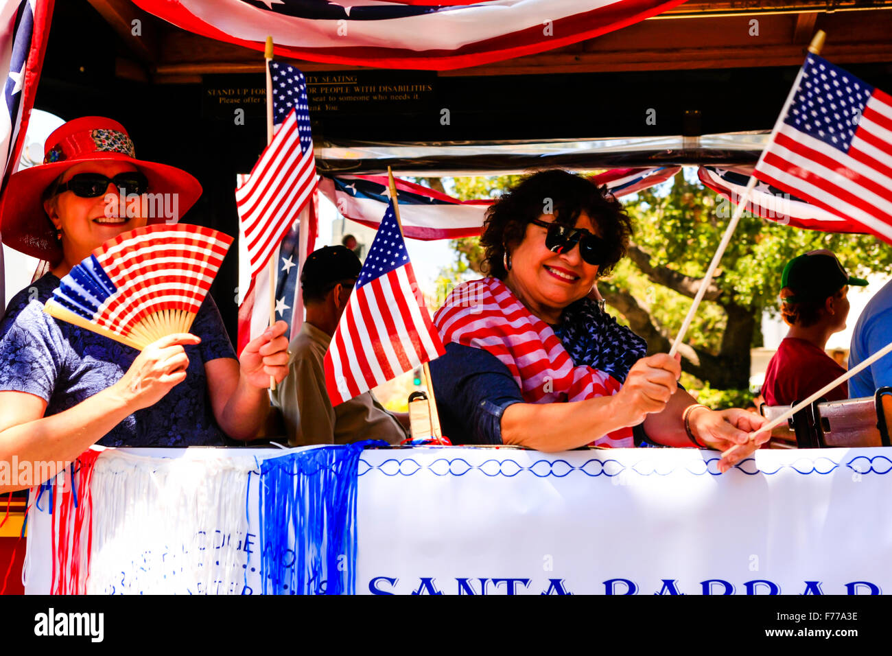 Daughters of the Revolution wave flags at the July 4th celebration