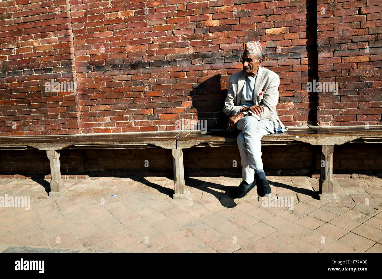 a Nepalese old man sitting alone, Patan Durbar Square, 2015, Patan, Lalitpur, Nepal Stock Photo