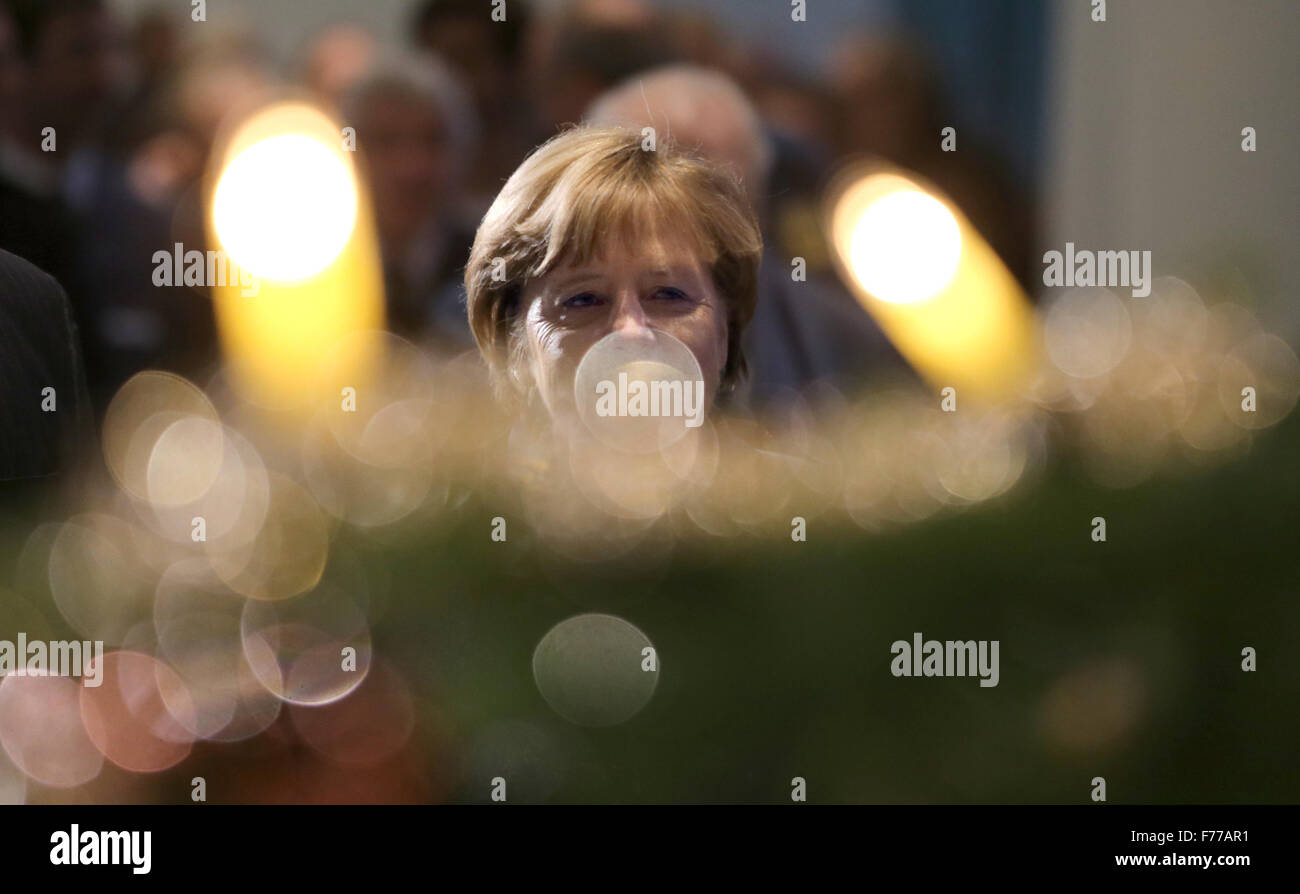 German Chancellor Angela Merkel (CDU) looks at the lights on a Christmas tree at the federal chancellery in Berlin, Germany, 26 November 2015. The Nordmann fir tree from the Gut Dobersdorf estate is one of three Christmas trees presented to Merkel, along with the German government's refugee coordinator and the integration commissioner. PHOTO: KAY NIETFELD/DPA Stock Photo