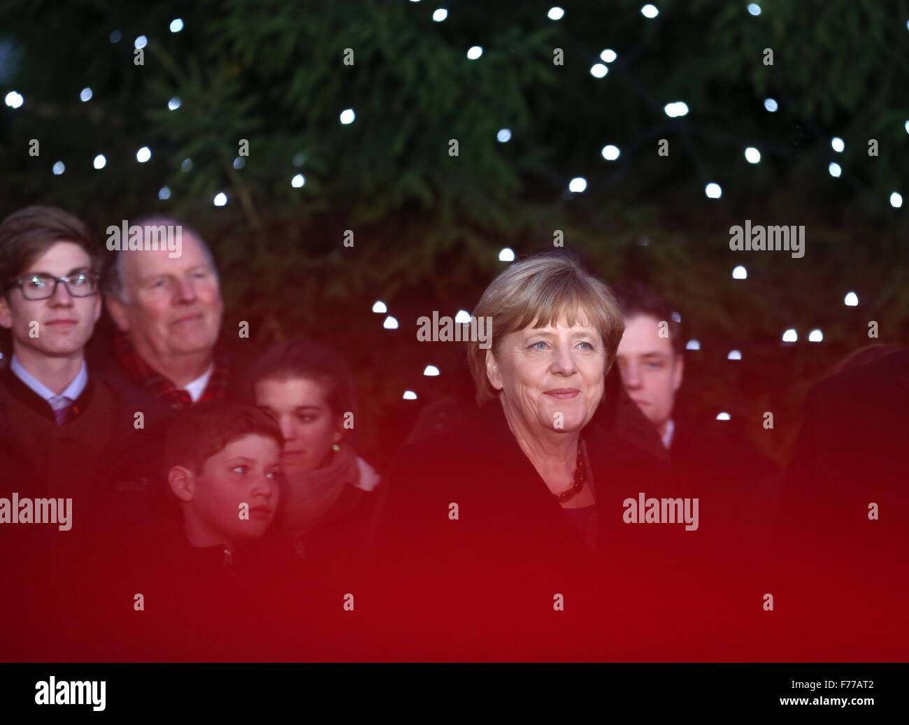 Berlin, Germany. 26th Nov, 2015. German Chancellor Angela Merkel (r, CDU) standing in front of a Christmas tree at the federal chancellery in Berlin, Germany, 26 November 2015. The Nordmann fir tree from the Gut Dobersdorf estate is one of three Christmas trees to Merkel, along with the German government's refugee coordinator Peter Altmaier (CDU) and integration commissioner Aydan Oezguz (SPD). PHOTO: KAY NIETFELD/DPA/Alamy Live News Stock Photo