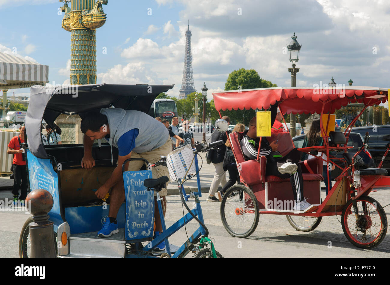 Two taxi trike's in Paris with the Eiffel Tower in the background Stock