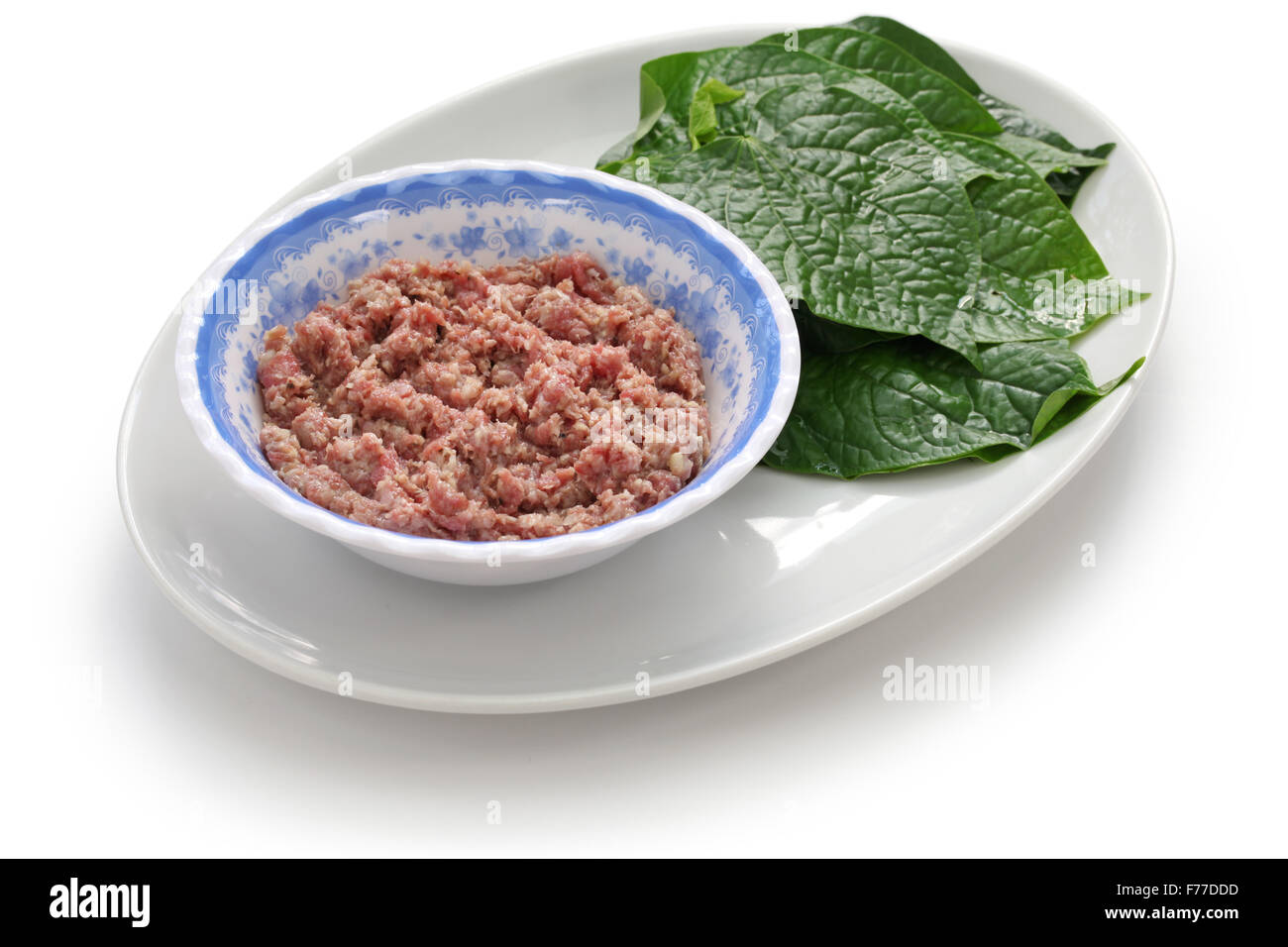 preparing bo la lot, vietnamese cuisine, grilled minced beef wrapped in betel leaf Stock Photo