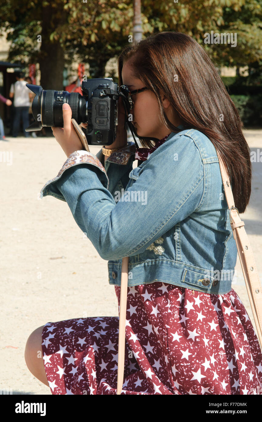 Female photographer composing her shot. Stock Photo