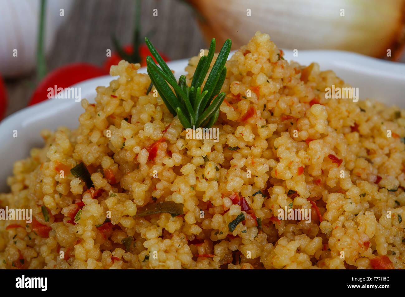 Arabic traditional cuisine Couscous with tomato and green onion Stock