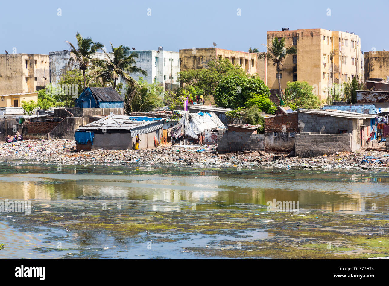 Third world poverty lifestyle: Apartment blocks, riverside shacks, slums on the banks of the polluted Adyar River estuary, Chennai, Tamil Nadu, India Stock Photo