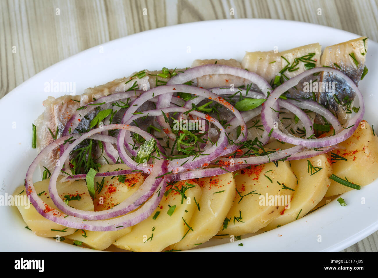 Herring with potato and onion traditional appetizer snack Stock Photo