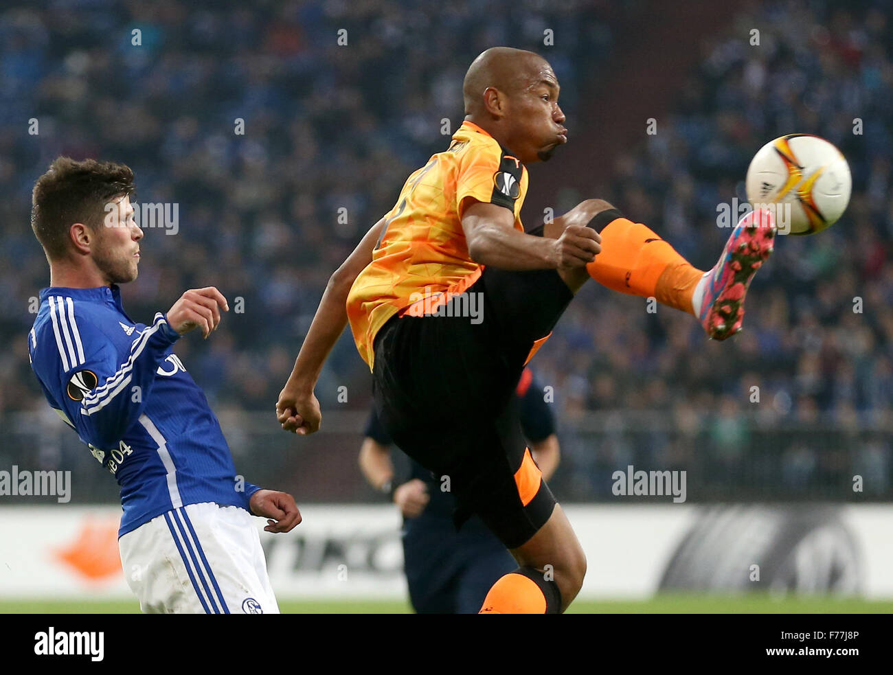 Gelsenkirchen, Germany. 26th Nov, 2015. Schalke's Klaas-Jan Huntelaar (l) and Nikosia's Joao Guilherme (r) compete for the ball during the Europa League Group K football match between FC Schalke 04 and APOEL Nikosia at the Veltins Arena in Gelsenkirchen, Germany, 26 November 2015. PHOTO: FRISO GENTSCH/DPA/Alamy Live News Stock Photo