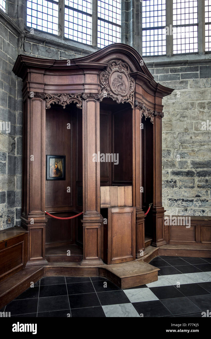 Old wooden confessional box, enclosed booth used for the Sacrament of Penance in church / cathedral Stock Photo