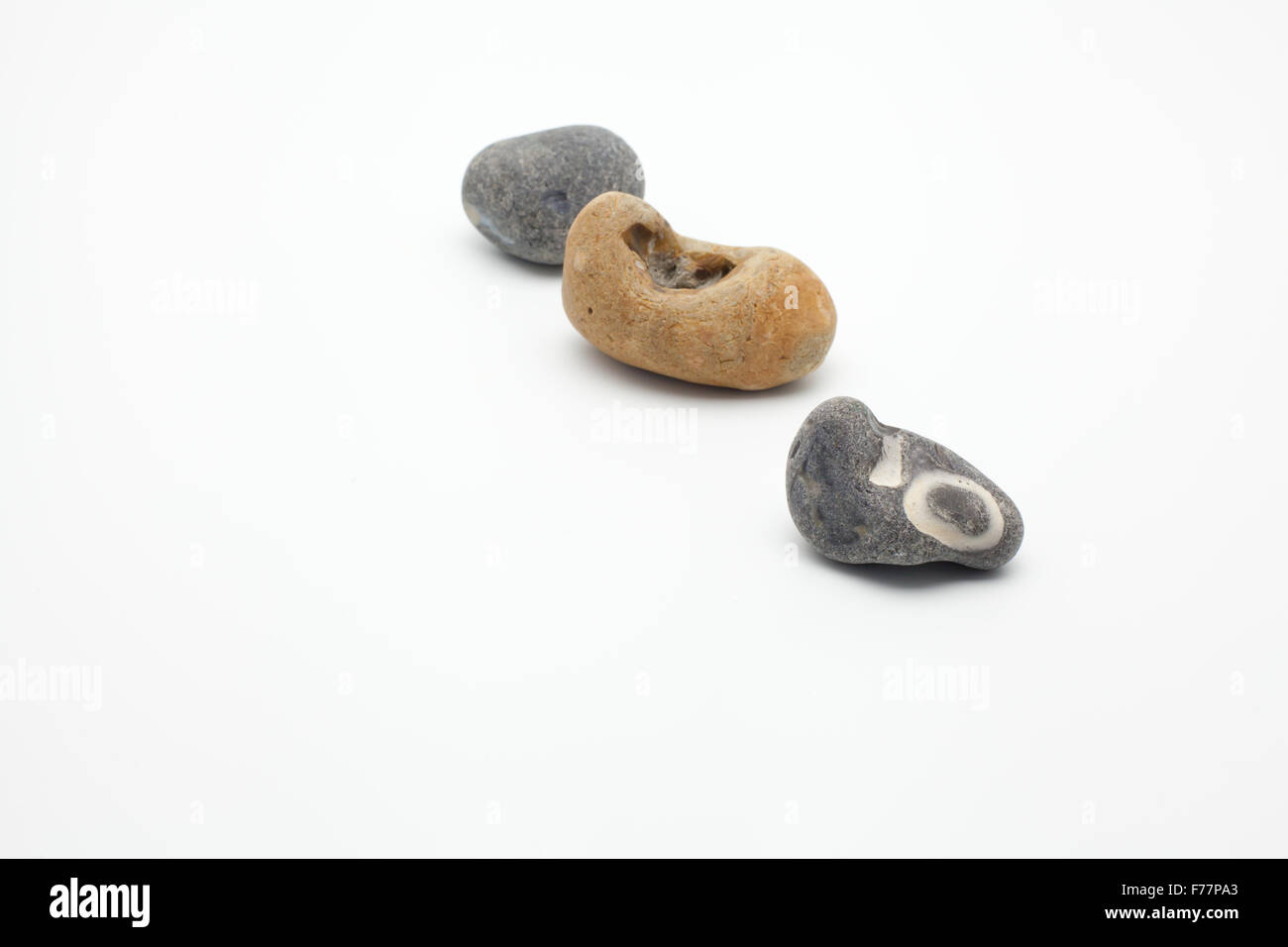 tiny group of pebbles on white Stock Photo