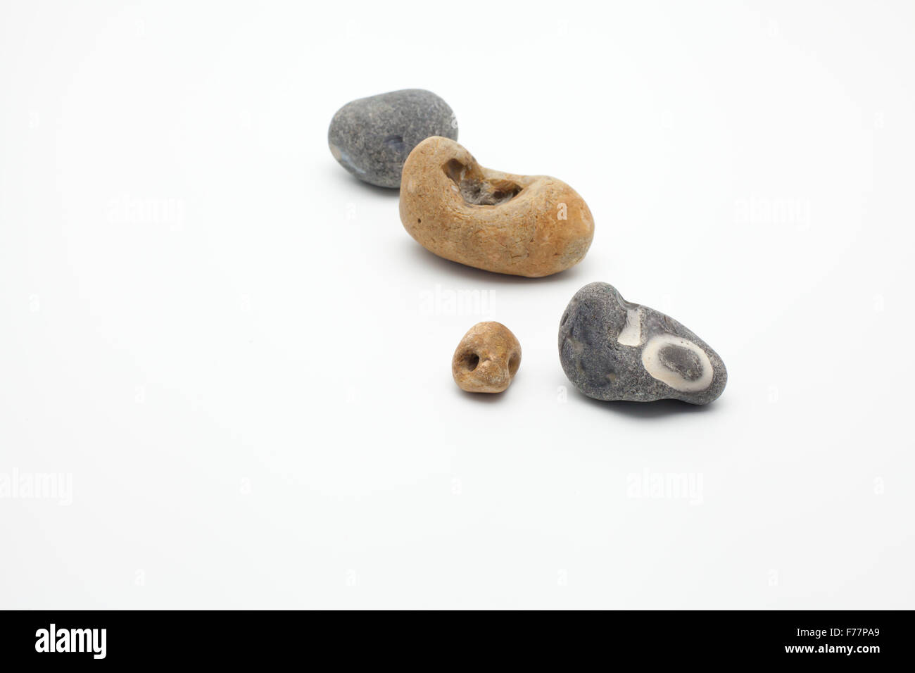 tiny group of pebbles on white Stock Photo