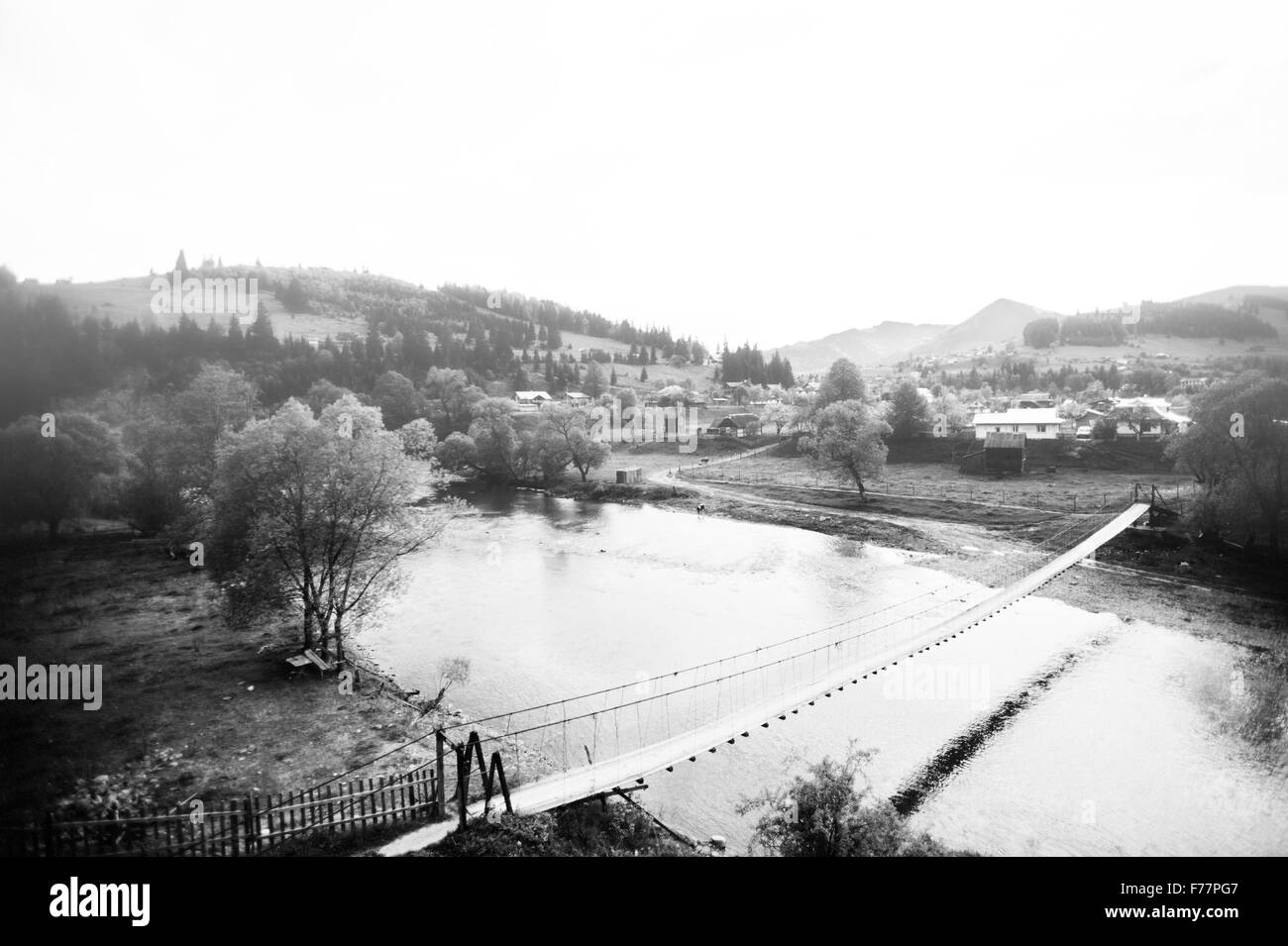 Suspension bridge over mountain river Black and White Stock Photos ...