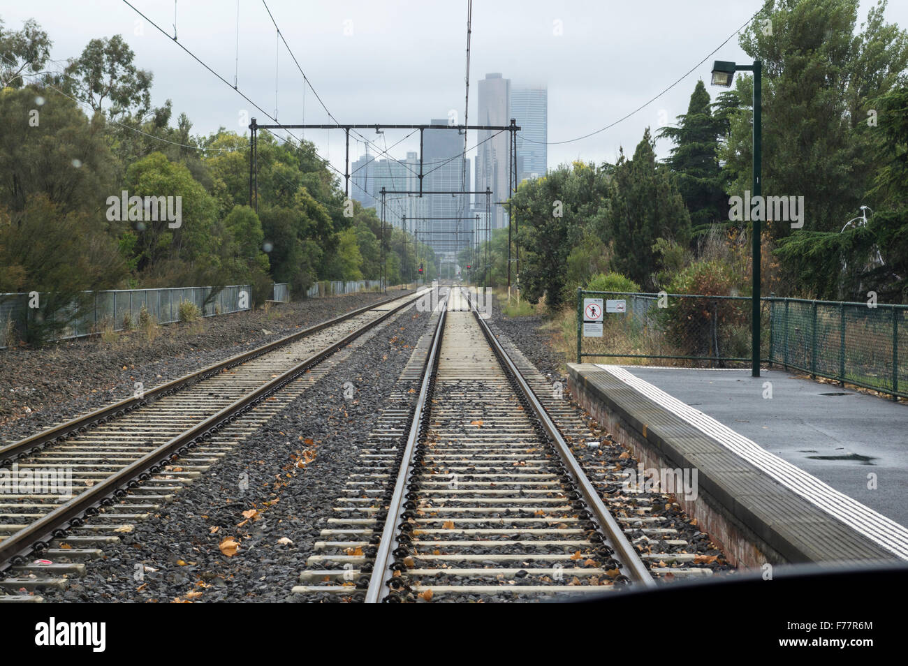 View from Graham Street station along the Melbourne Tramways tracks towards downtown Melbourne, Victoria, Australia, on a rainy, foggy day. Stock Photo