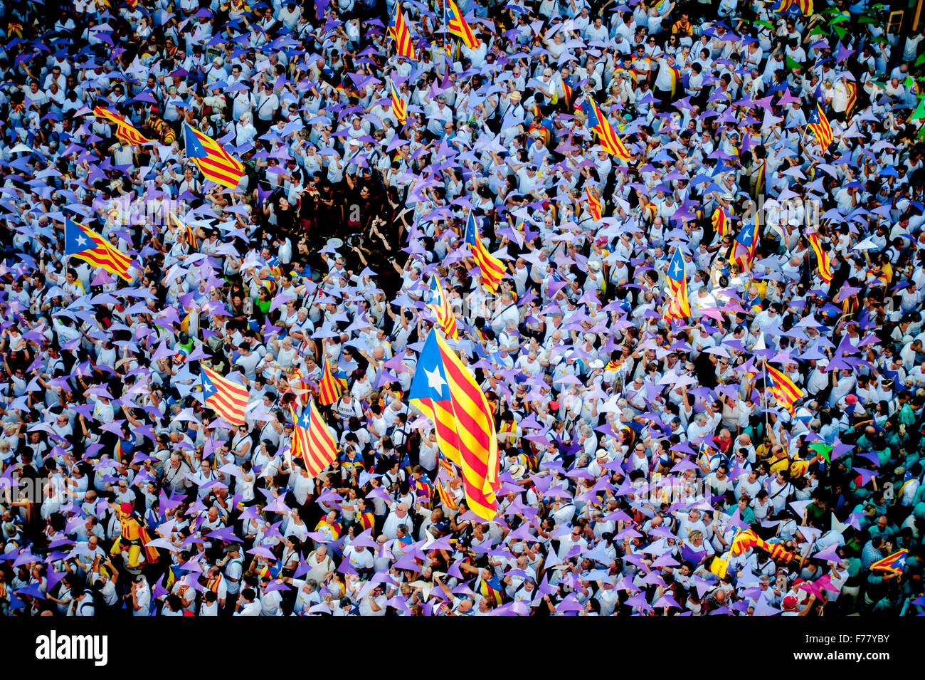 People trying choreographed with pieces of colored paper during the National Day of Catalonia Stock Photo