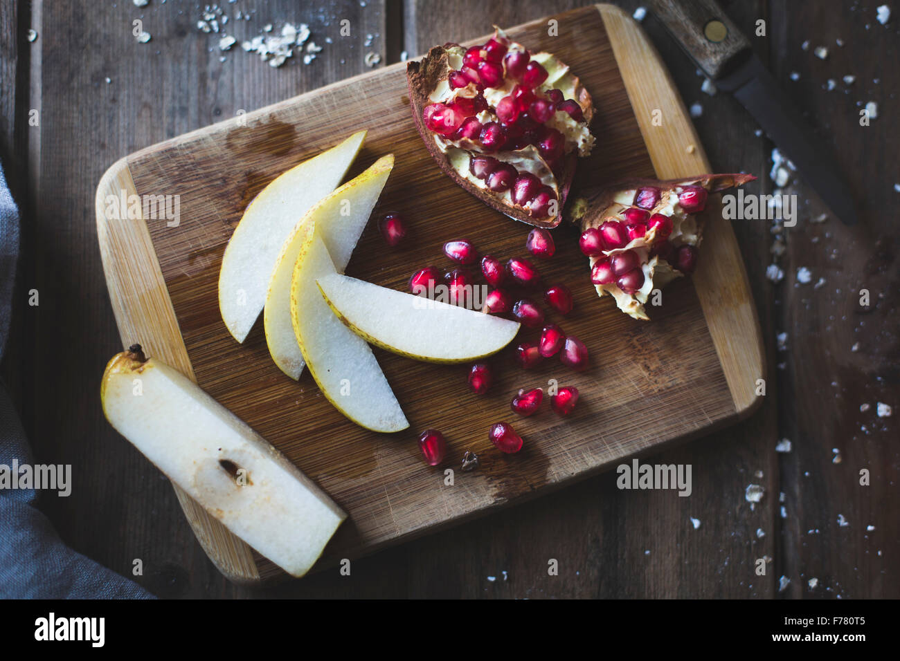 Pomegranate and Pear on a chopping board Stock Photo