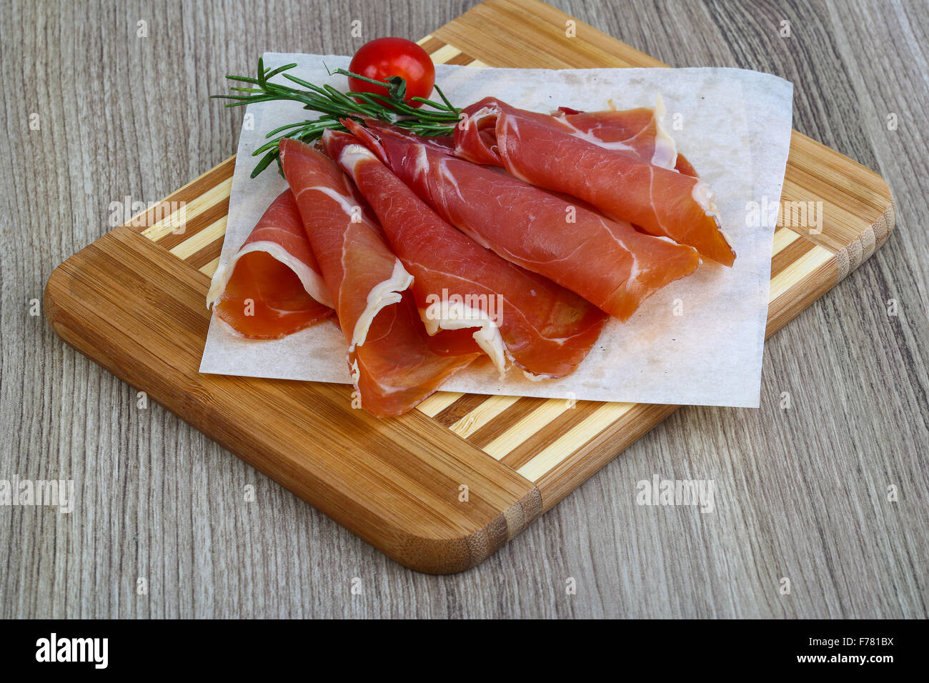 Spanish traditional snack Jamon with tomato and rosemary Stock Photo