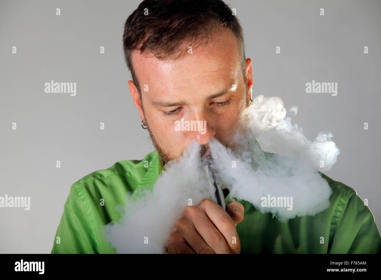 Man blows vapor out of his nose Stock Photo Alamy