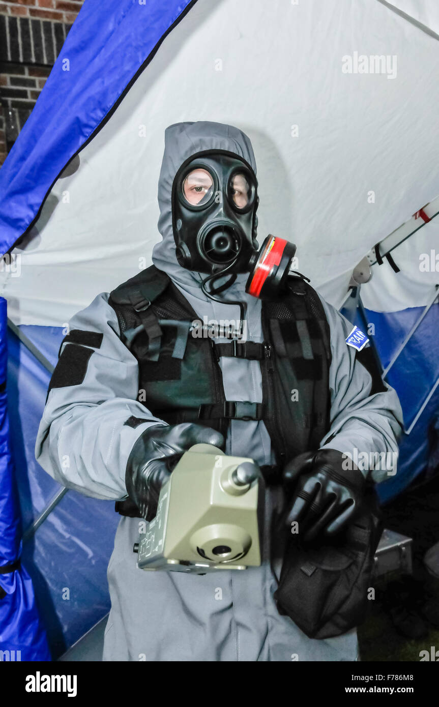 Northern Ireland. 26th November, 2015. A police officer from the Police Service of Northern Ireland wears a chemical, biological, radiological and nuclear (CBRN) protective suit and mask, while holding a geiger counter to check for radiation. Credit:  Stephen Barnes/Alamy Live News Stock Photo