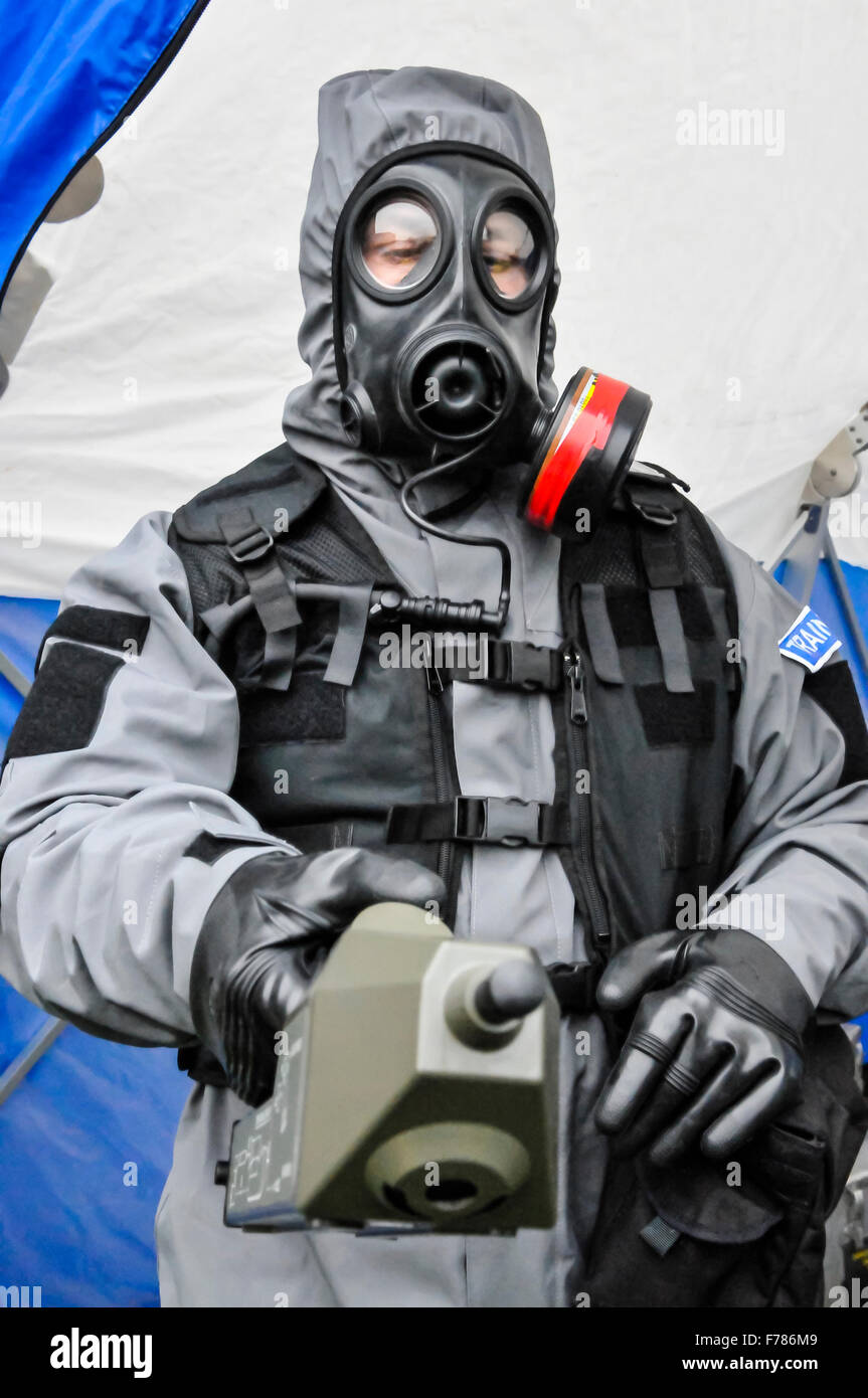 Northern Ireland. 26th November, 2015. A police officer from the Police Service of Northern Ireland wears a chemical, biological, radiological and nuclear (CBRN) protective suit and mask, while holding a geiger counter to check for radiation. Credit:  Stephen Barnes/Alamy Live News Stock Photo