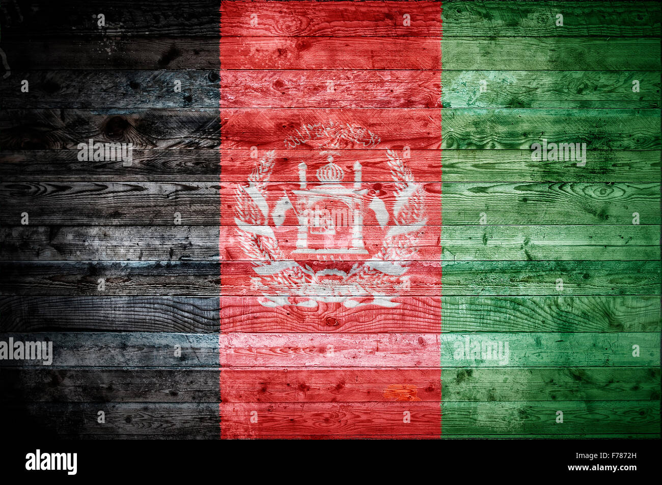 A vignetted background image of the flag of Afghanistan painted onto wooden boards of a wall or floor. Stock Photo