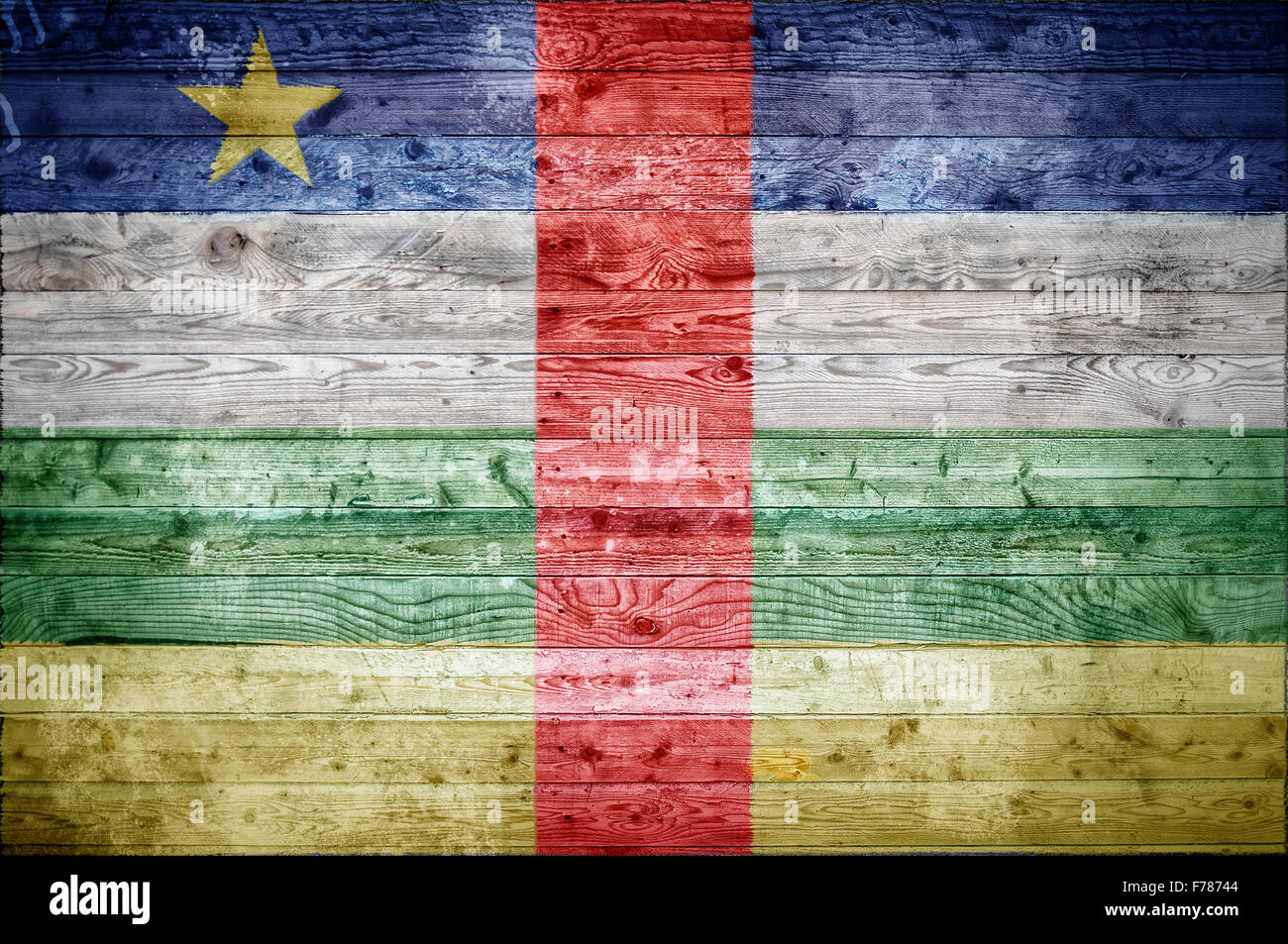 A vignetted background image of the flag of Central African Republic painted onto wooden boards of a wall or floor. Stock Photo