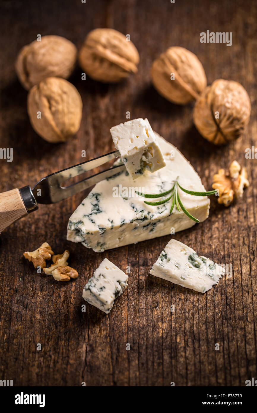 Tasty blue cheese with walnut on vintage wooden surface Stock Photo