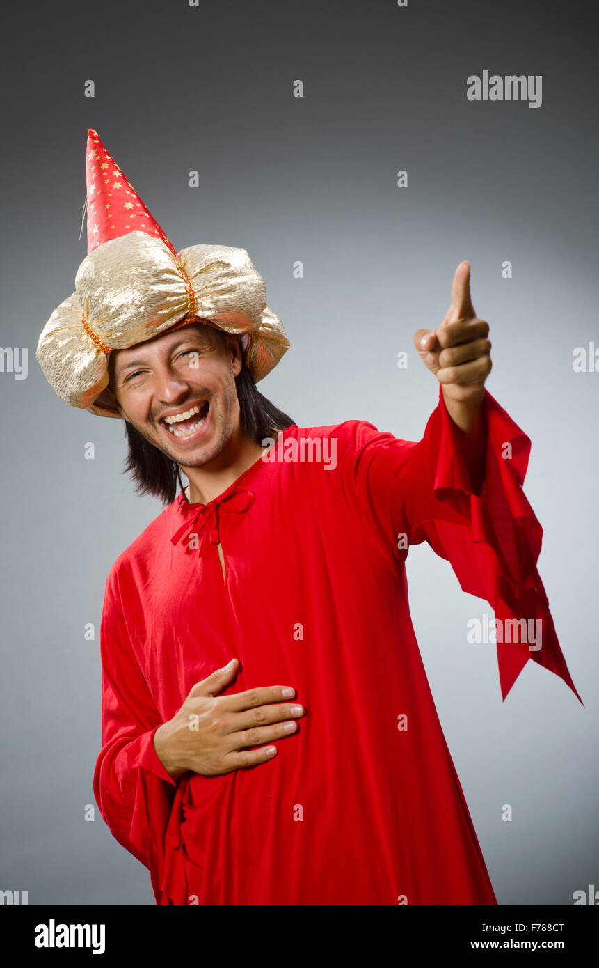 Funny wizard wearing red dress Stock Photo - Alamy