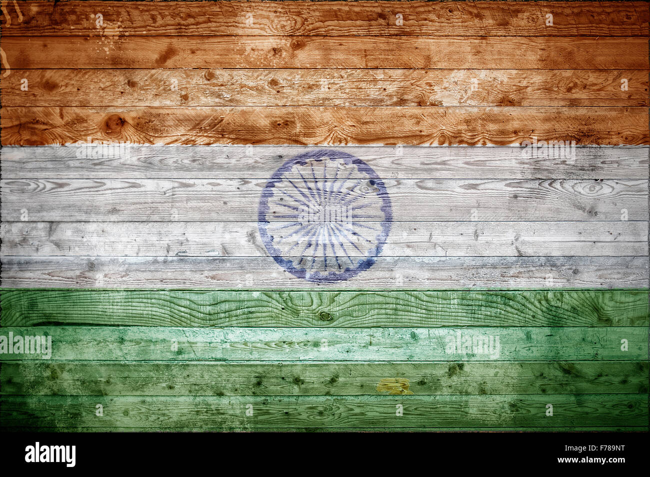 A vignetted background image of the flag of India painted onto wooden boards of a wall or floor. Stock Photo