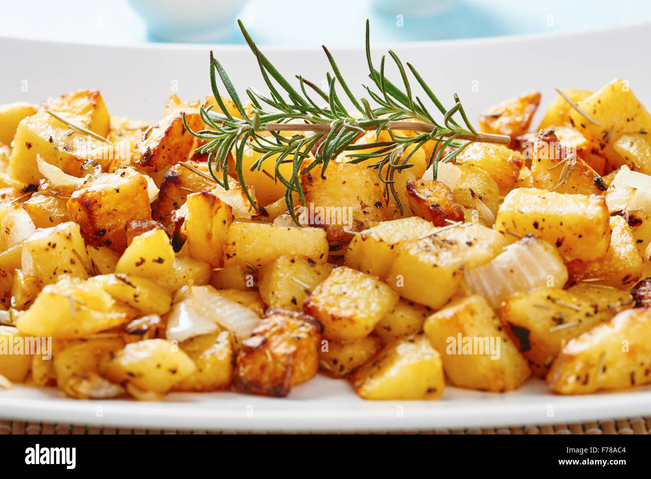 Roasted potatoes on square white plate Stock Photo Alamy