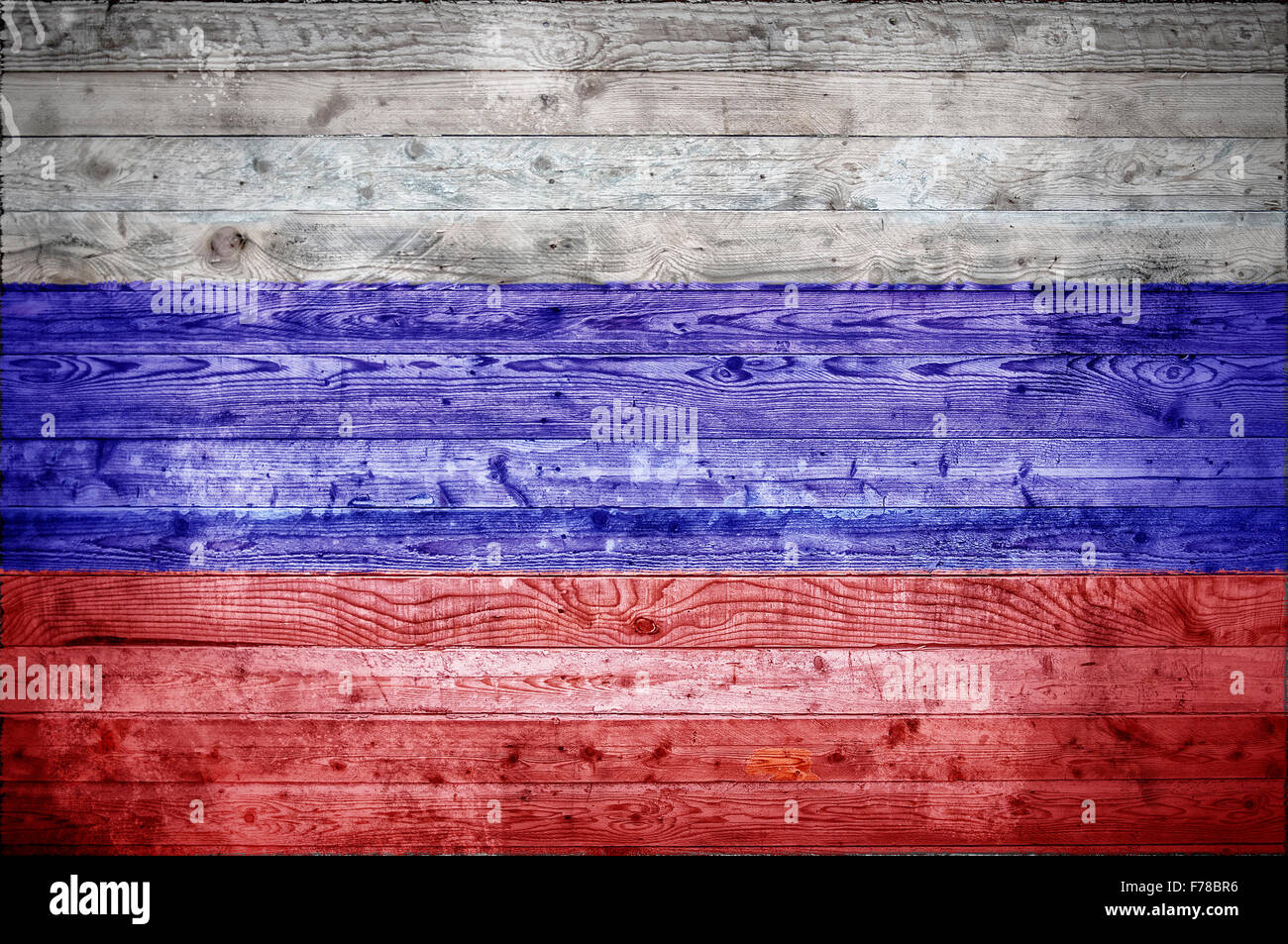 A vignetted background image of the flag of Russian Federation onto wooden boards of a wall or floor. Stock Photo