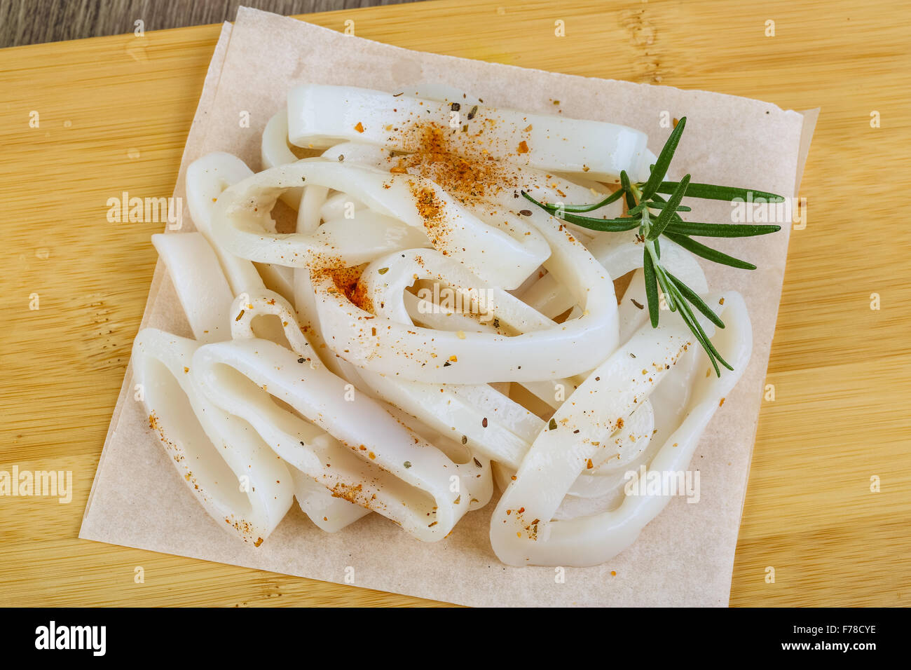 Raw squid rings with rosemary and spices - ready for cooking Stock