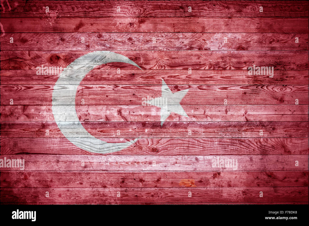 A vignetted background image of the flag of Turkey onto wooden boards of a wall or floor. Stock Photo