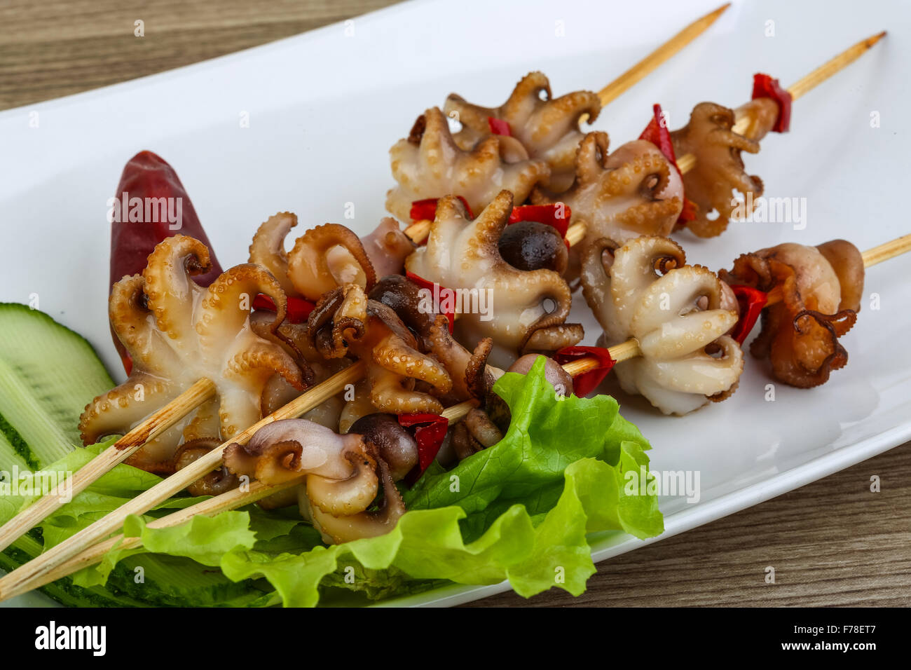 Grilled octopus skewers with red pepper and onion Stock Photo Alamy