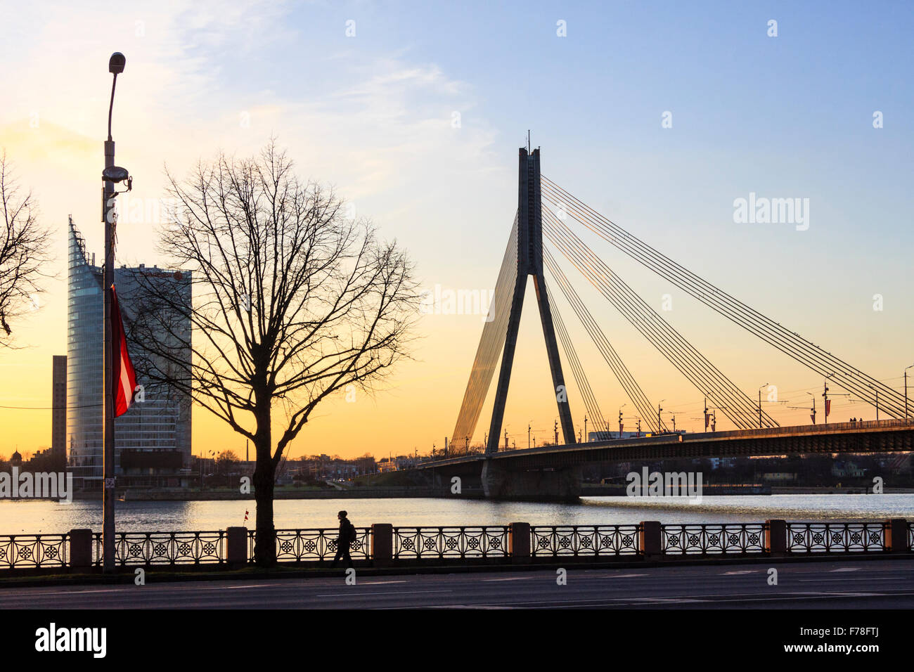 Riga, Latvia. SwedBank Tower and Vansu bridge on Daugava river at sunset. Stock Photo