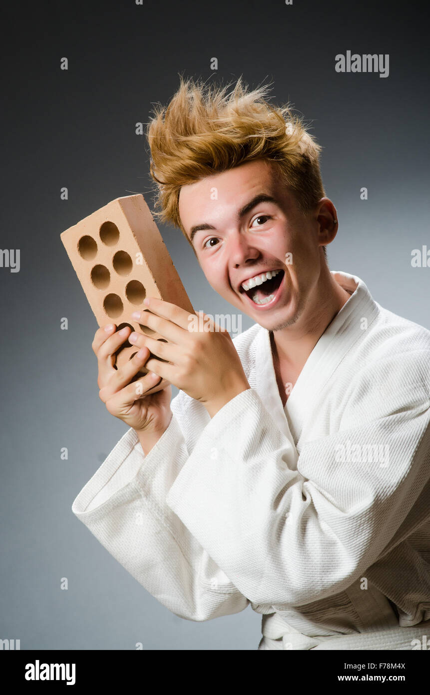 Funny karate fighter with clay brick Stock Photo - Alamy
