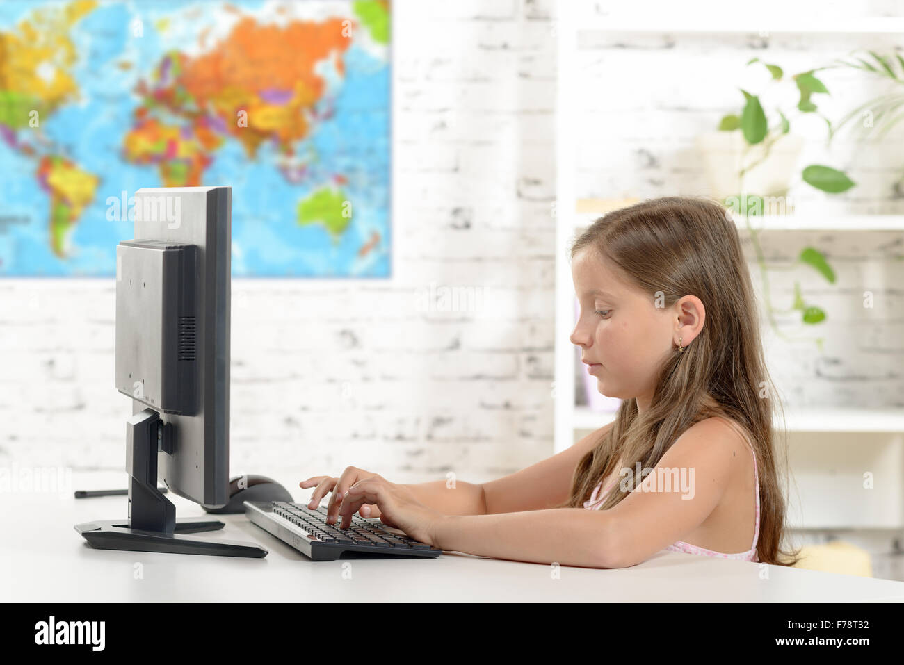 a schoolgirl with a computer in the classroom Stock Photo - Alamy