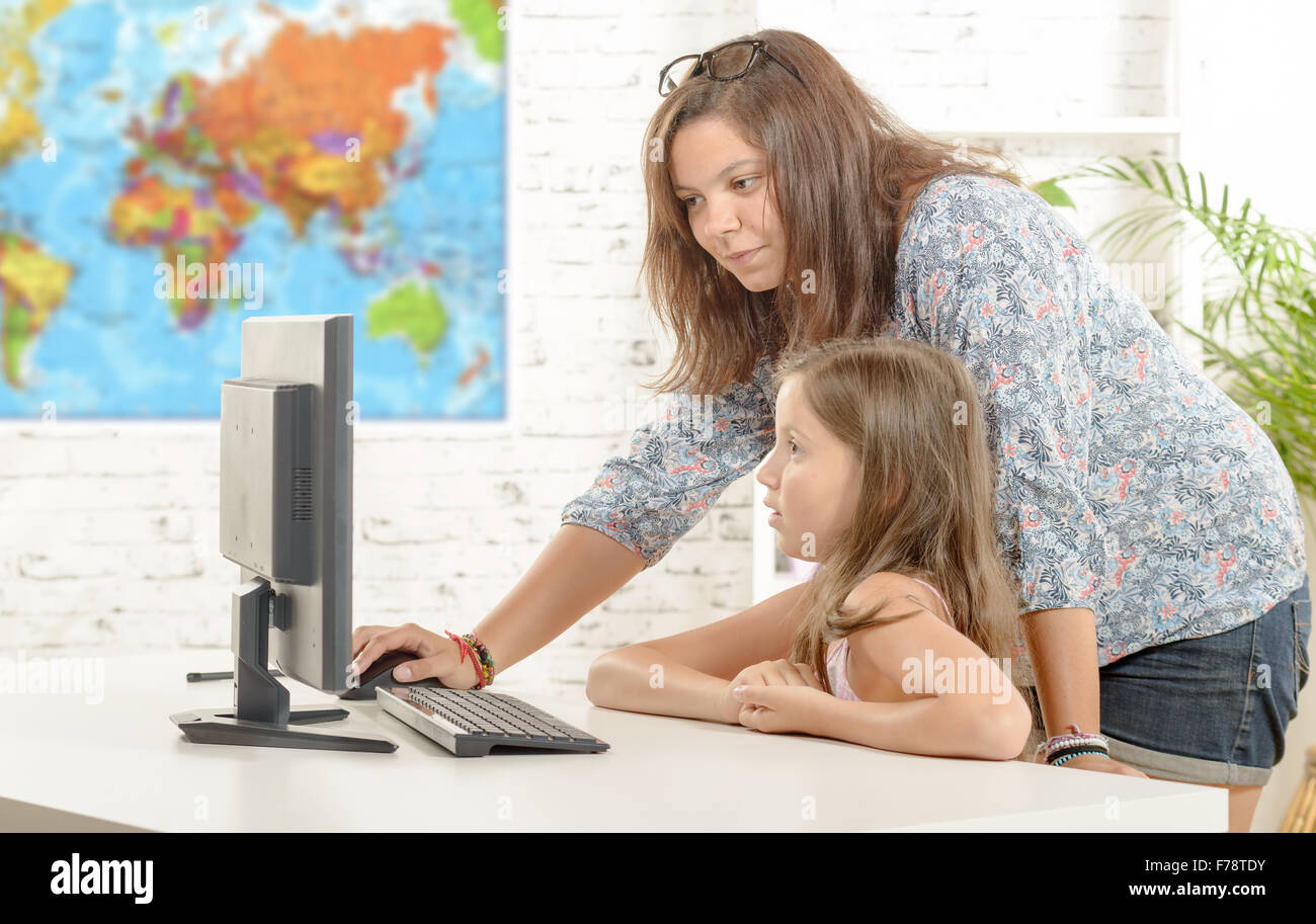 a teacher and a school girl with a computer Stock Photo - Alamy